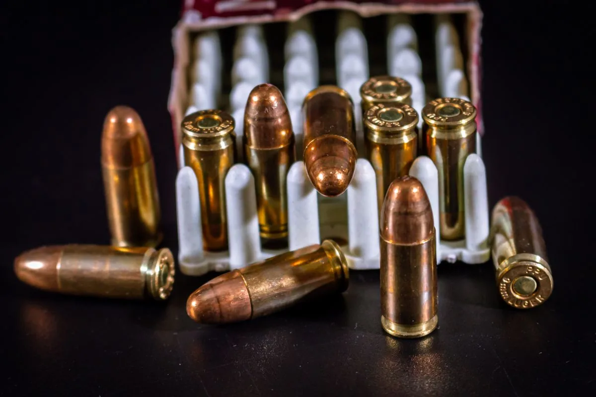 How to choose reloading primers: brass cartridges and a box of ammunition on the reloading bench