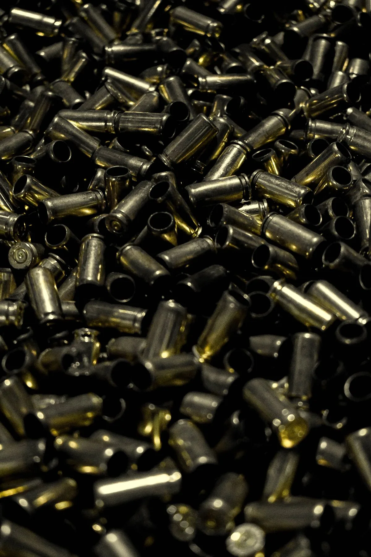 Is reloading worth it: a large pile of once-fired brass cases ready to reload and save money