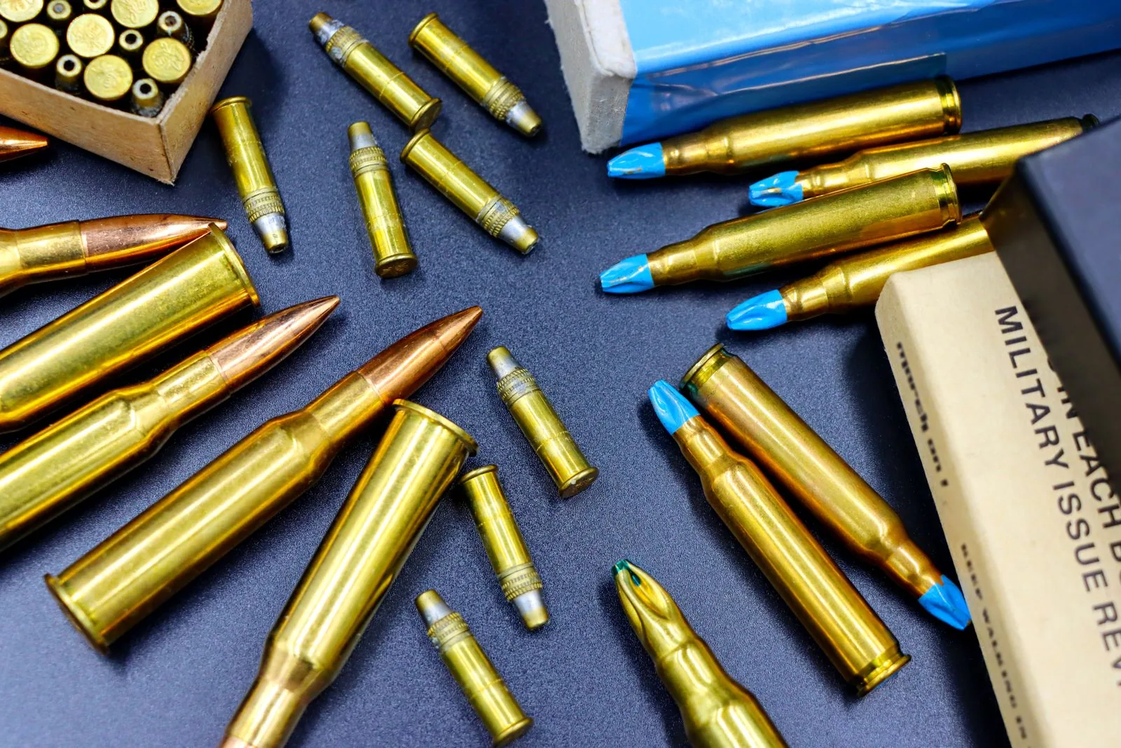 reloading equipment list — assorted rifle cartridges and ammunition boxes