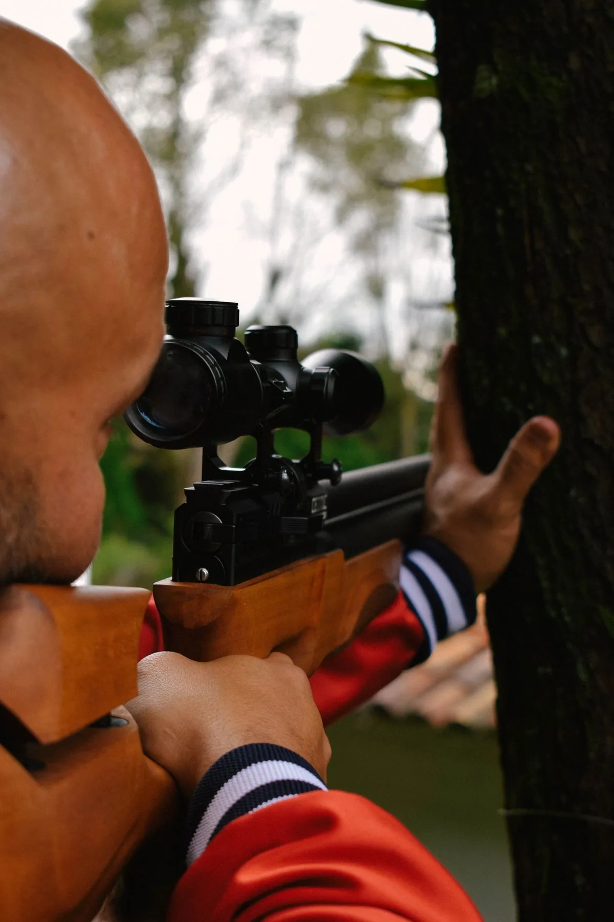 Spin drift and Coriolis in play as a shooter aims a scoped rifle downrange