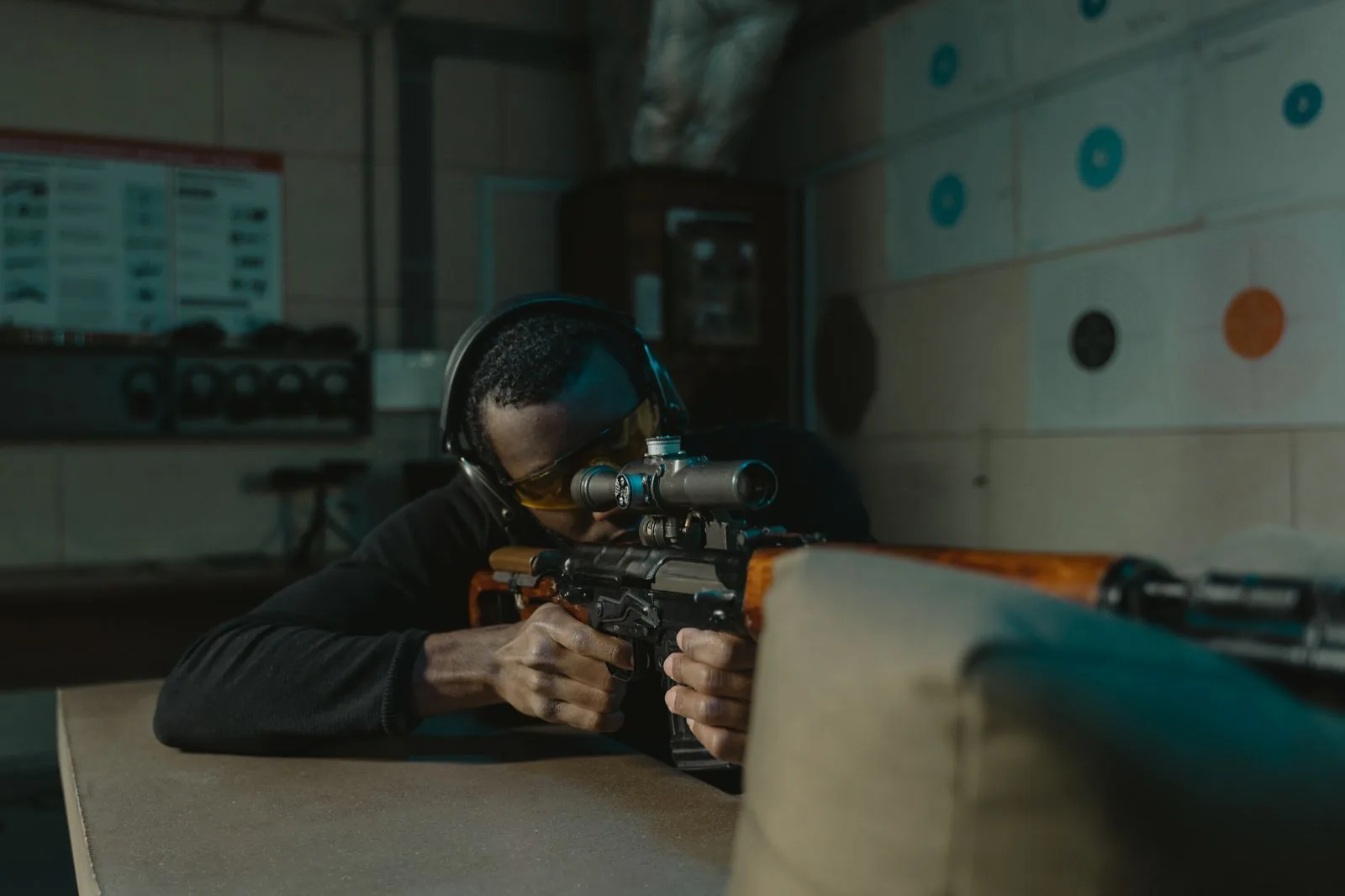 how to true a ballistic calculator: a shooter behind a scoped rifle at the range